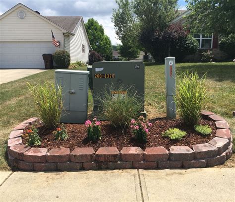 hide electrical box in yard|how to hide utility boxes.